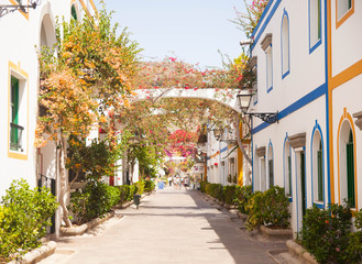 Gran Canaria, Spain - Typical architecture of Puerto de Mogan, a small fishing port of Gran Canaria. Colorfull flowers blooming around houses.