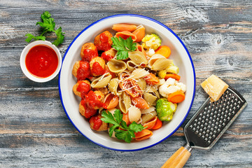 Meatballs with Conchiglie, broccoli and a cauliflower in a plate on a table. Diet food. Top view.