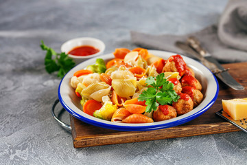 Meatballs with Conchiglie, broccoli and a cauliflower in a plate on a table. Diet food.