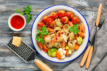 Meatballs with Conchiglie, broccoli and a cauliflower in a plate on a table. Diet food. Top view.