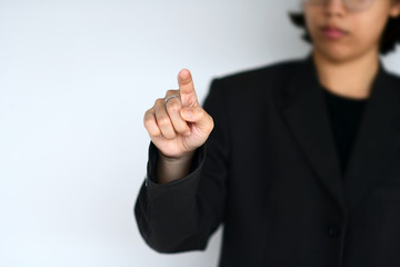 Business person in suit working point the air acts like a digital virtual screen, focus on the hand and blurred background