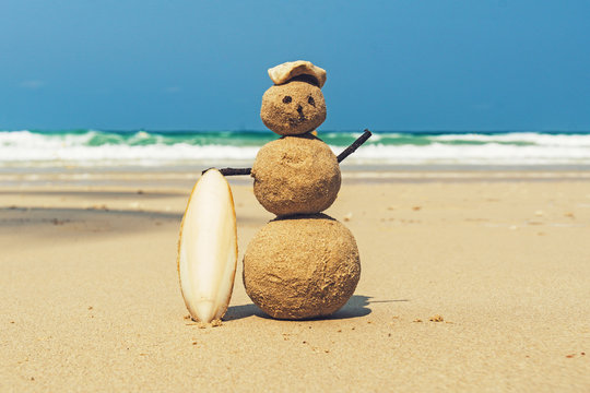 Sandman with blue sea background. snowman of sand stands on a clean sandy beach. yellow sand on the shore of the Andaman sea, tropical island. beautiful sea landscape