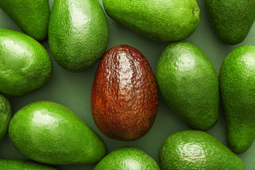 Fresh avocados on color background