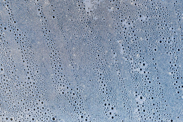 Background of the condensate drops on the film is polyethylene. Water drops texture