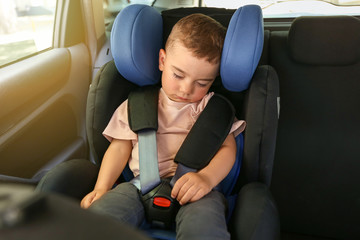 Sleeping baby boy buckled in car seat
