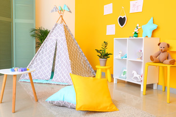 Interior of modern children's room with teepee