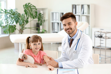 Fototapeta premium Doctor vaccinating little girl in clinic