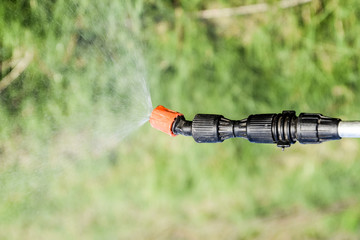 Spraying herbicide from the nozzle of the sprayer manual
