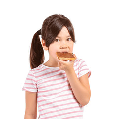 Funny little girl eating tasty toast on white background