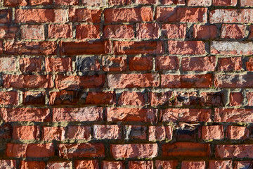 Destroyed by time and precipitation brick wall.