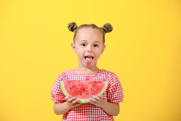 Cute little girl with slice of fresh watermelon on color background