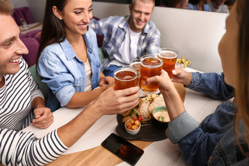 Friends drinking fresh beer in pub