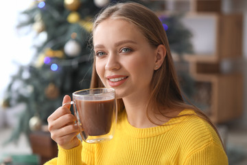 Beautiful woman drinking hot chocolate at home