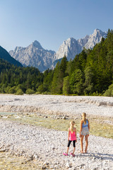 Children by the river near village Kranjska Gora in Triglav national park, Slovenia