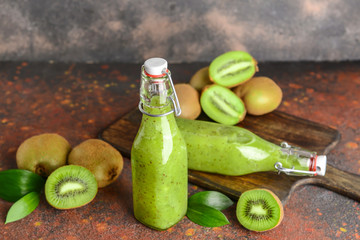 Bottles of tasty kiwi smoothie on table
