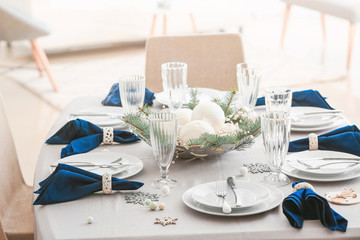 Festive table setting for Christmas dinner at home