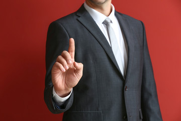 Businessman using virtual screen on color background