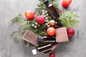 Christmas composition with candles and products for spa treatment on grunge background