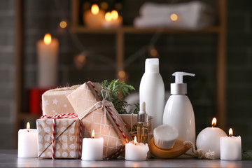 Christmas gift boxes with products for spa treatment on table