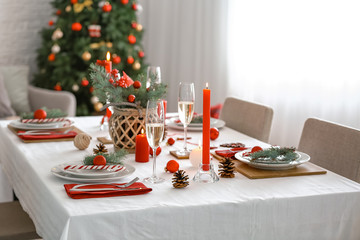 Beautiful table setting with Christmas decorations in living room