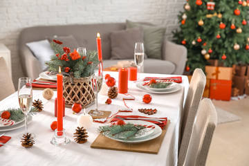 Beautiful table setting with Christmas decorations in living room