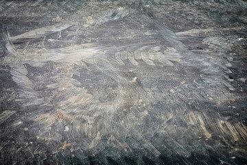 Dirty track imprints on asphalt, faded background.