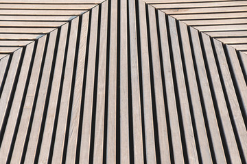 Abstract wooden striped background with pronounced shadows.