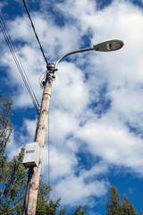 Fototapeta na wymiar old streetlamp against summer sky