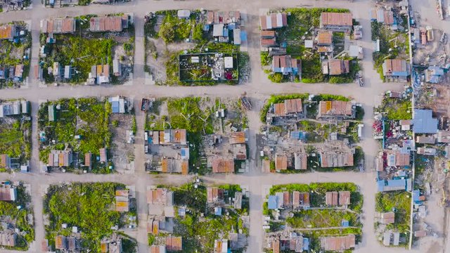 Aerial top-down view high altitude of slum a heavily populated urban informal settlement characterized builders and wage workers substandard housing, squalor poor living conditions streets trailers