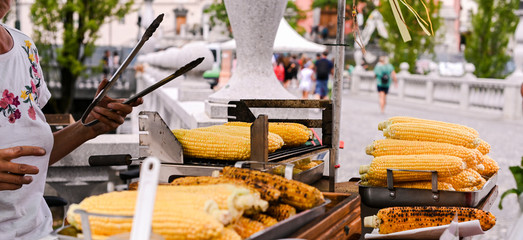 Grilled corn. Fast food in the city center for tourists. Selling food on the street.