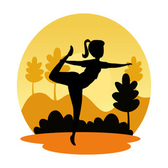 silhouette of woman practicing pilates on the landscape sunset scene