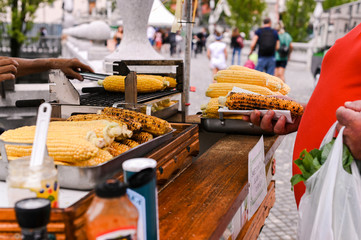 Grilled corn. Fast food in the city center for tourists. Selling food on the street.