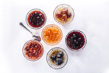 Set of jam collection with different berries and fruits isolated on white background