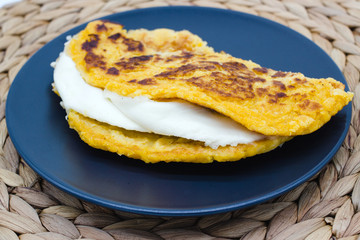 Cachapas on a rustic background. Close-up of Cachapa, a traditional food from Venezuela, Costa Rica and Colombia made with maize flour and cheese