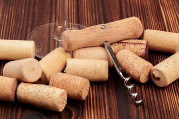 Corkscrew with cork. On a wooden background. - Image