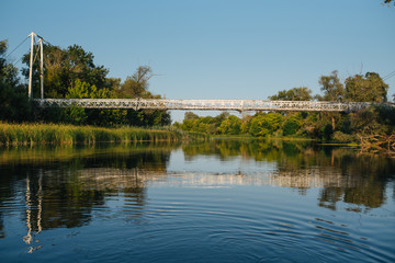 Bridge on river in sunset lights.