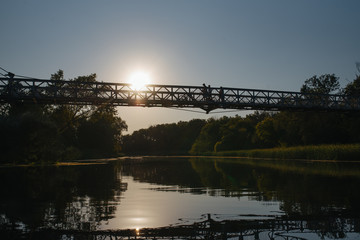 Bridge on river in sunset lights.
