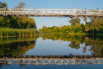 Bridge on river in sunset lights.