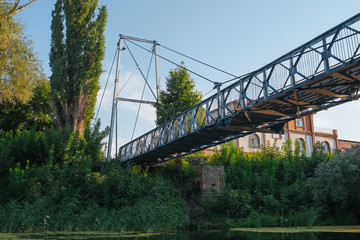 Bridge on river in sunset lights.