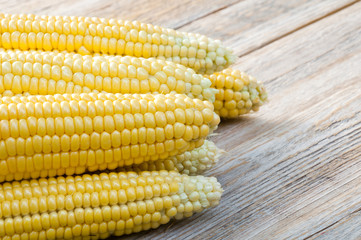 Sweet corn cobs on a wooden table