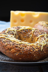 Tasty baked bagels with melted french emmental cheese