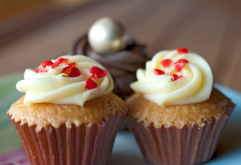 Three cupcakes on the plate indoor
