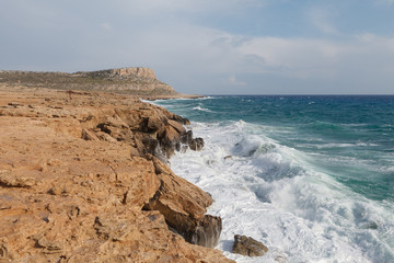 Rocky shore of Cyprus with waves crashing