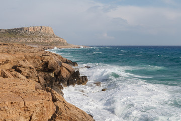 Rocky shore of Cyprus with waves crashing