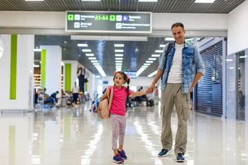 Fototapeta premium father and little daughter walking in the airport, family travel