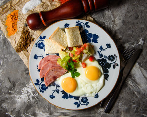 breakfast fried eggs with bread and salad