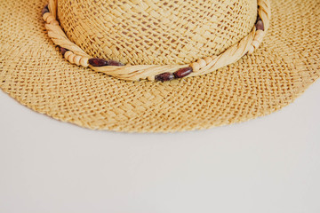 Beautiful straw hat on white background, beach hat from a side top view