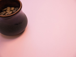 Coffee beans in coffee cup on pink background copy space coral trend
