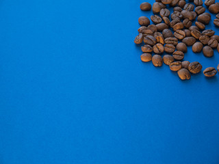Coffee beans on blue background copy space coral trend