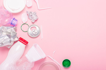 Garbage collection, plastic and metal on a pink background. Concept stop plastic, recycling,...